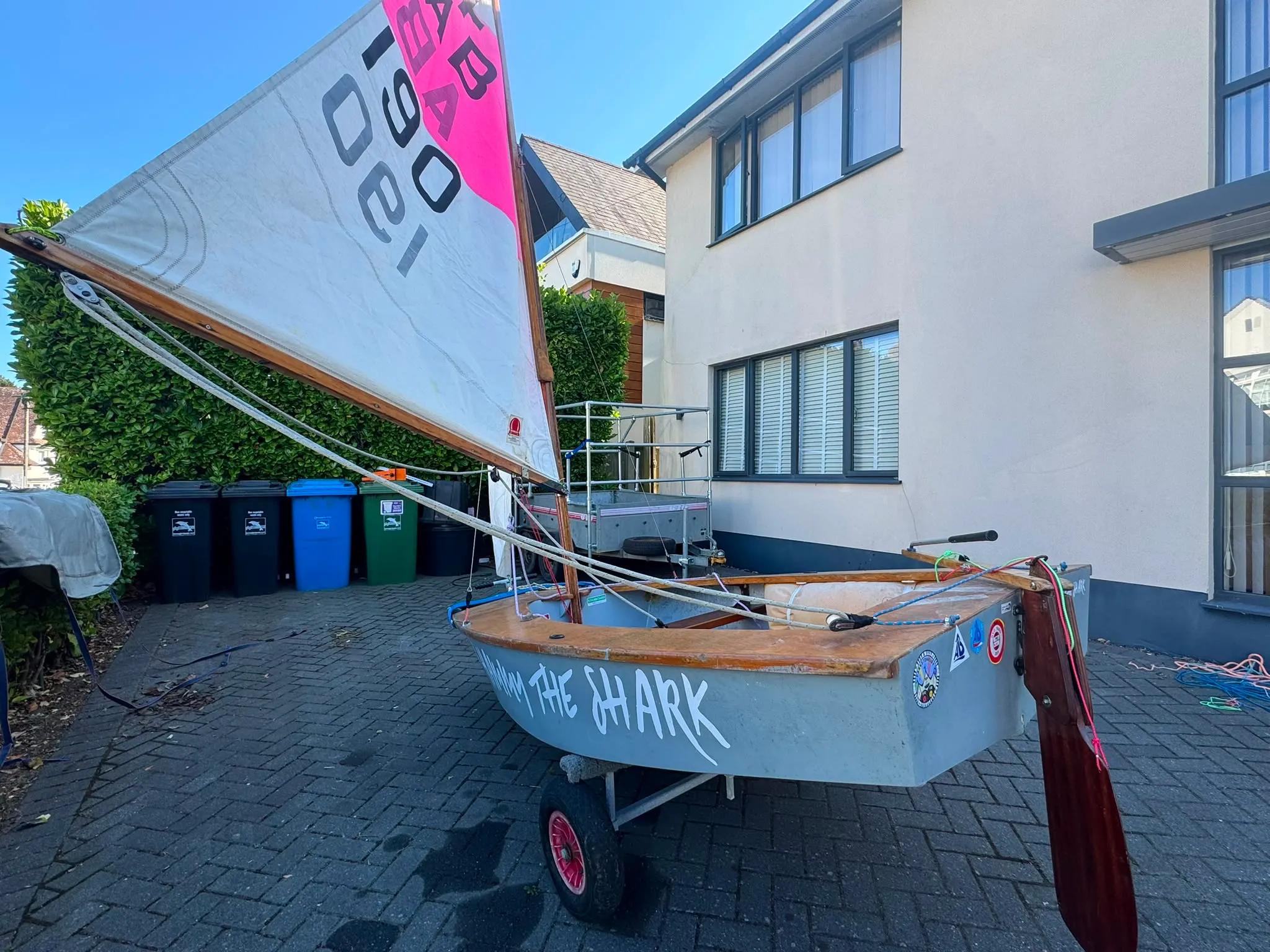 Hammy the Shark from the stern quarter, the name along her side, stickers on the transom and the rudder hung behind.